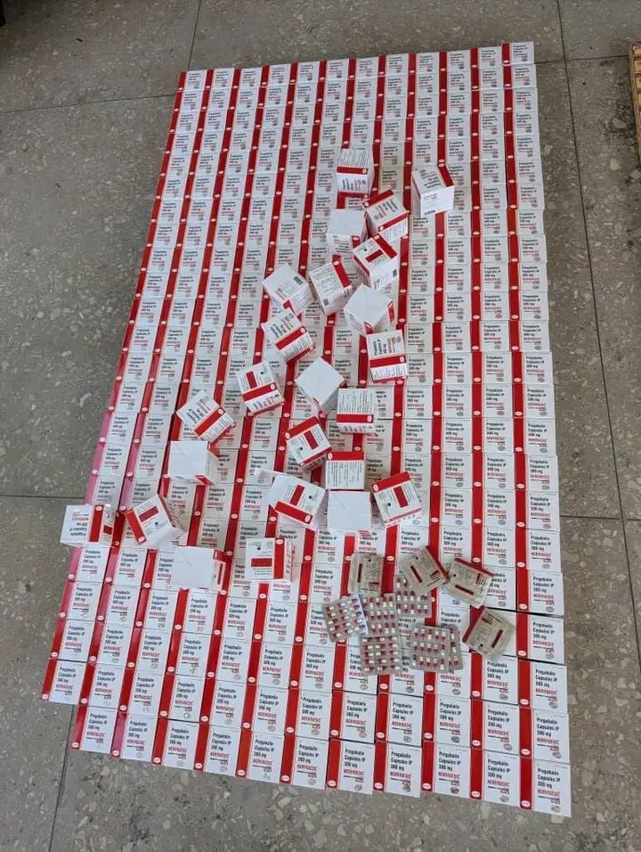 Police officers display seized Tramadol and Pregabalin drugs in Kano