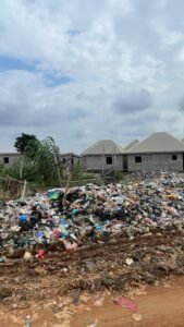 Image of an open dumpsite in Karonmajiji, where children play dangerously close to heaps of refuse (Image credit: Chukwu Obinna/AHR,2025)