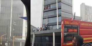 Firefighters and rescue workers outside Afriland Towers in Lagos