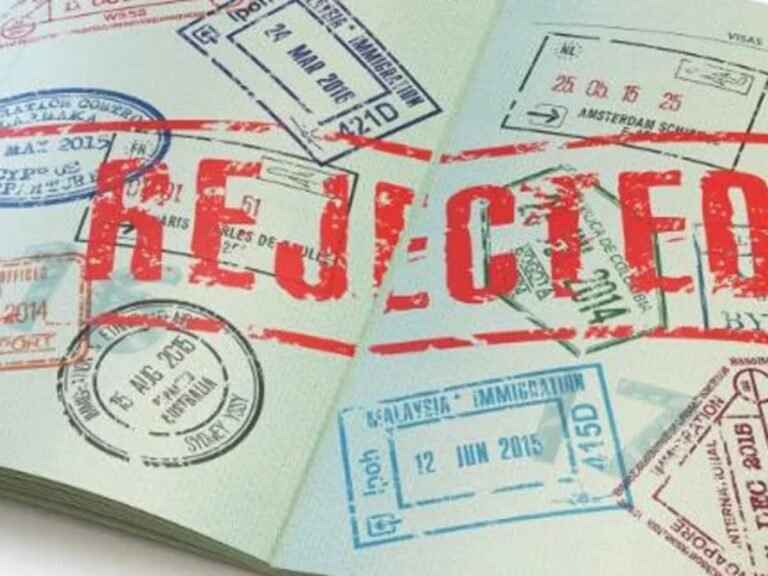 A Nigerian passport showing a visa application page stamped “Rejected” in bold red ink.