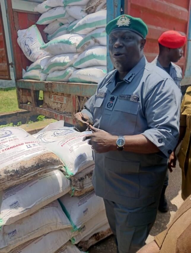 Customs officers display intercepted expired flour and drugs worth ₦1.9bn at Seme Border.