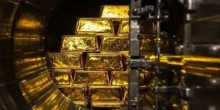 Gold bars stacked in a vault representing investment demand