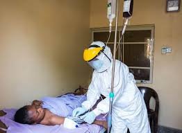 Health worker prepares protective gear during Lassa fever response in Nigeria
