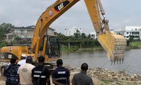 Lagos enforcement team inspecting illegal waterfront reclamation site