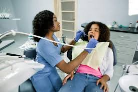 A Nigerian dentist attends to a young patient at a public hospital, , highlighting the growing oral health crisis and limited access to preventive care in Nigeria.