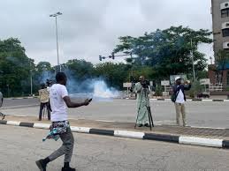 Police officers firing tear gas at #ReleaseNnamdiKanuNow protesters in Abuja