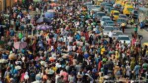 Nigerians walking in a crowded market as inflation and poverty bite