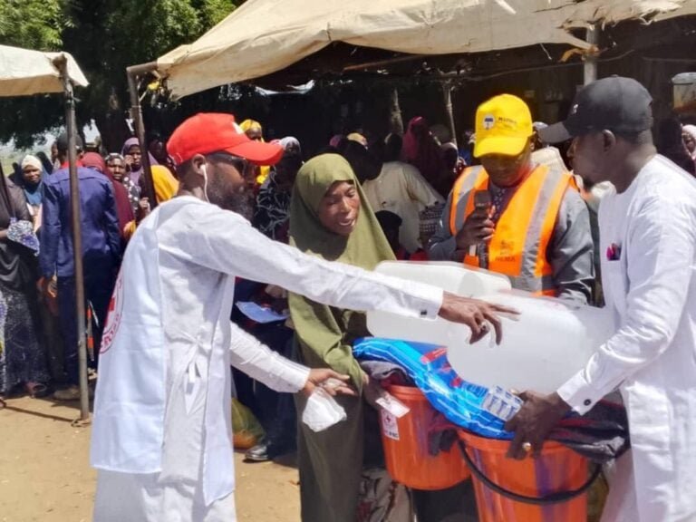 NEMA and the Nigerian Red Cross distribute relief items to displaced families in Ramin Kura IDP Camp following severe flooding in Sokoto.