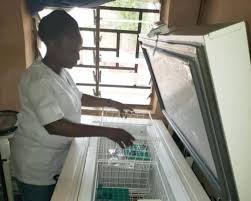 A nurse arranges vaccine vials inside a clinic in Abuja, highlighting Nigeria’s lack of adult immunisation services.