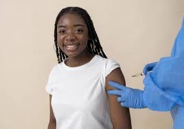 Girls receiving HPV vaccination at a low-income country immunisation centre