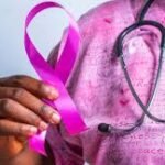 Healthcare professional conducting breast cancer awareness examination.