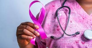 Healthcare professional conducting breast cancer awareness examination.