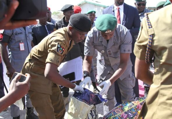 Nigeria Customs officers inspecting seized containers in Kano