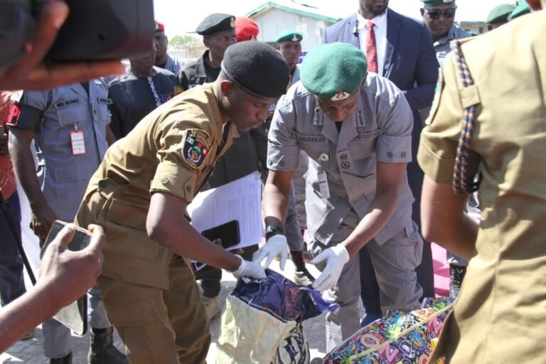 Nigeria Customs officers inspecting seized containers in Kano