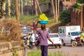 Child hawker navigating traffic in Abuja street