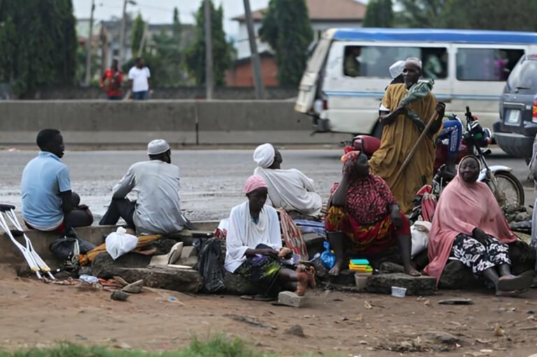 Security officials arresting street beggars in Abuja