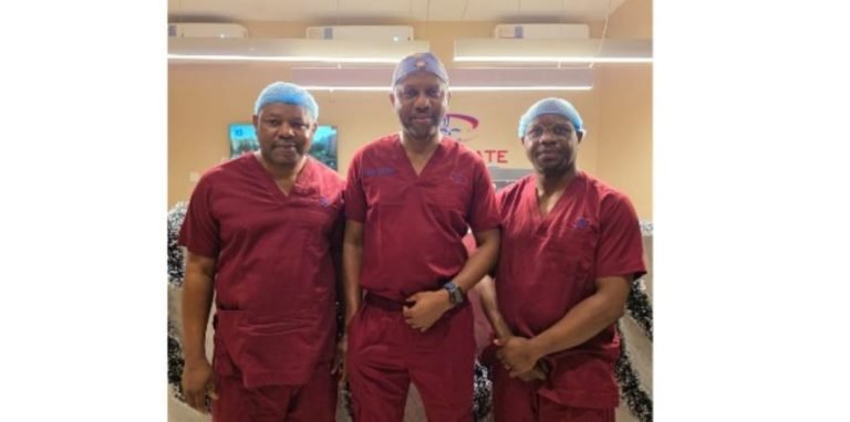 Surgeons operating robotic surgery equipment in Lagos