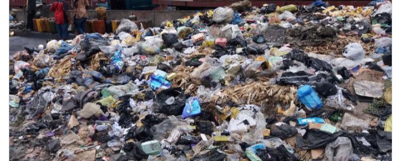 Blocked drainage channel filled with refuse in Ekiti State