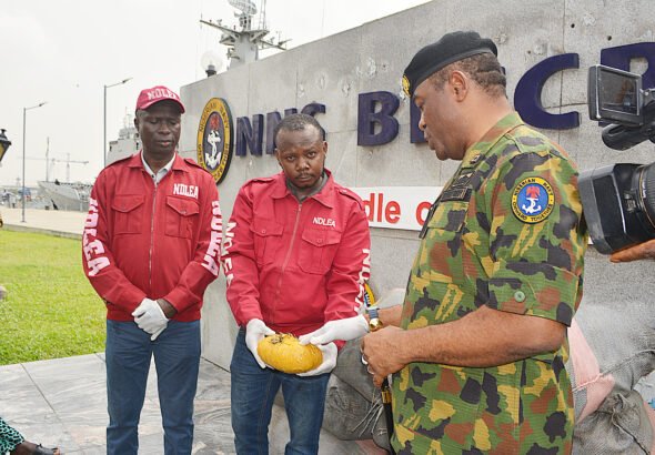 Nigerian Navy officers handing over seized cannabis to NDLEA