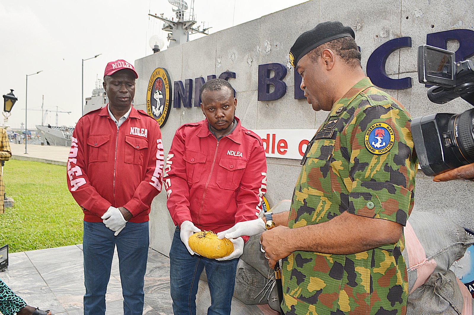 Nigerian Navy officers handing over seized cannabis to NDLEA