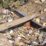 Stagnant drainage filled with animal waste beside Kubwa Market in Abuja
