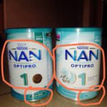 Mother checking expiry date on baby food tin in a Nigerian supermarket 2