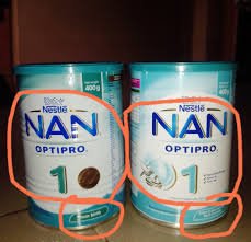 Mother checking expiry date on baby food tin in a Nigerian supermarket 2