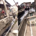 Children in school uniform standing on makeshift structures in Makoko