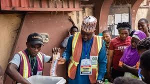 Nigerian election officials preparing ballot materials at polling centre