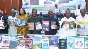 Nigerian education minister presenting locally authored academic textbooks under TETFund initiative