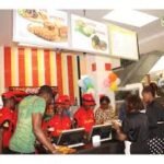 Busy fast food outlet in Abuja with customers queuing for affordable meals