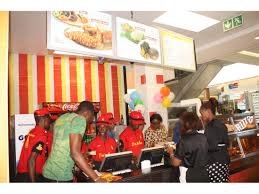 Busy fast food outlet in Abuja with customers queuing for affordable meals