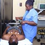 Doctor explaining sodium balance to patient in Nigerian clinic