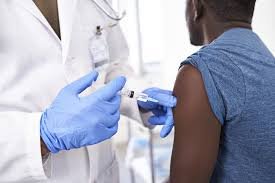 Healthcare worker administering hepatitis vaccine
