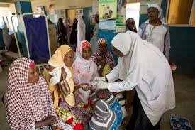 Nigerian health workers attending to patients in a primary healthcare centre