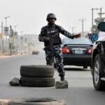 Police checkpoint stopping vehicles on Abuja highway