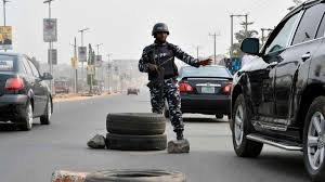 Police checkpoint stopping vehicles on Abuja highway