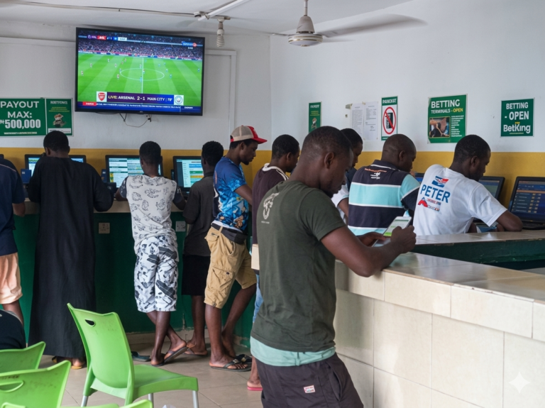 Young Nigerians engaging in sports betting at a betting shop in Abuja