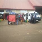 Travellers waiting beside interstate buses at Kubwa motor park in Abuja before Eid-ul-Adha