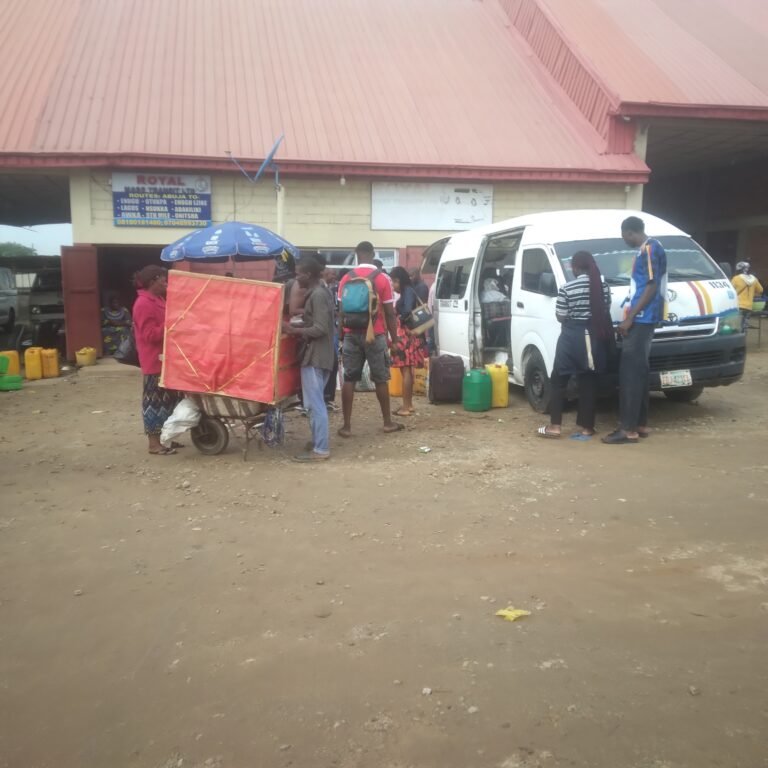 Travellers waiting beside interstate buses at Kubwa motor park in Abuja before Eid-ul-Adha