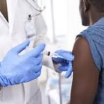Healthcare worker administering hepatitis vaccine