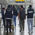 Police operatives involved in international fraud investigation and extradition process
