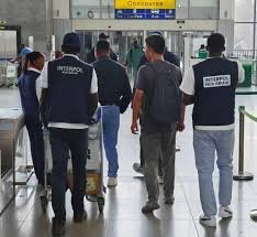 Police operatives involved in international fraud investigation and extradition process