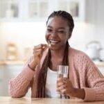 Young Nigerian woman holding medication in a private setting