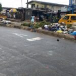 Large heaps of refuse along council Bus Stop, Ikotun
