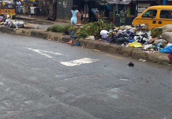 Large heaps of refuse along council Bus Stop, Ikotun