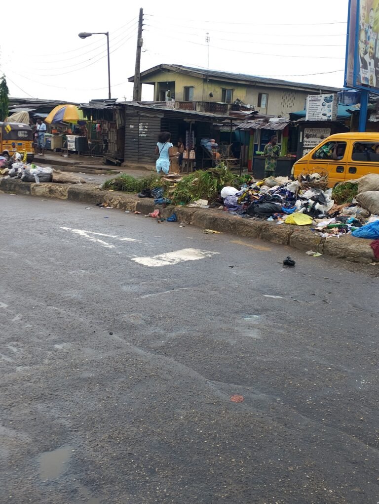 Large heaps of refuse along council Bus Stop, Ikotun
