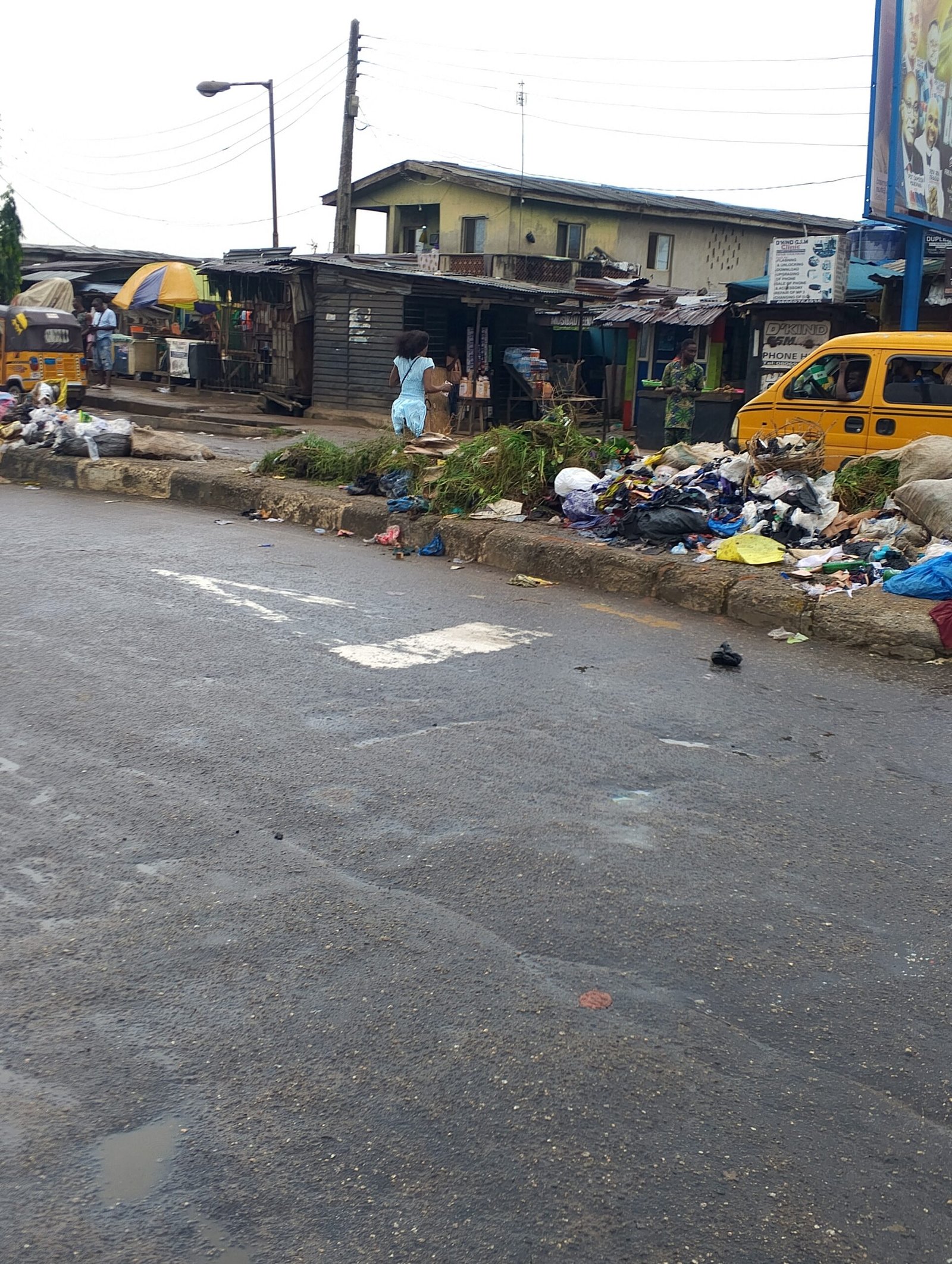 Large heaps of refuse along council Bus Stop, Ikotun