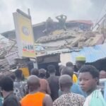 Emergency responders at the scene of a collapsed building in Alakija, Lagos.
