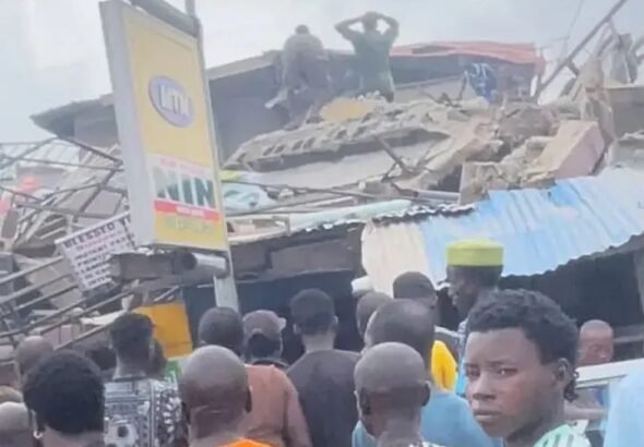 Emergency responders at the scene of a collapsed building in Alakija, Lagos.